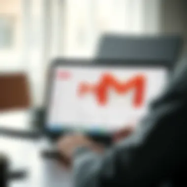 A person using a laptop to access Gmail through a web browser