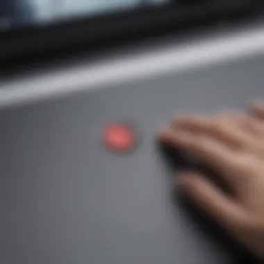 Person gently pressing power button on Chromebook